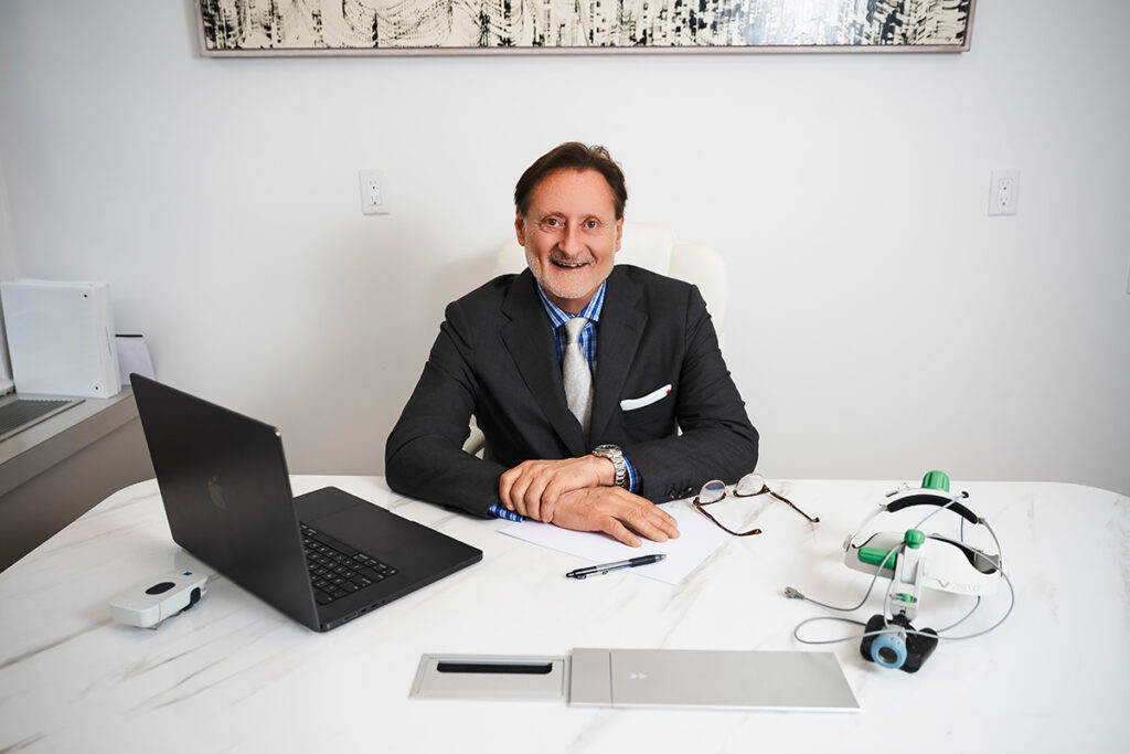 Dr. John P. Cole hair transplant surgeon in his clinic's office