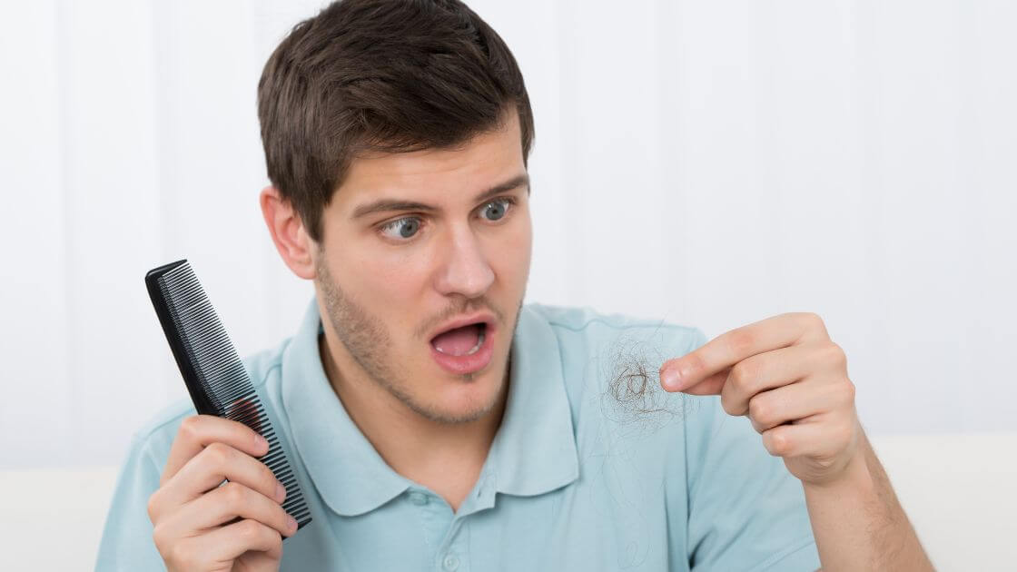 A man is surprised when noticing his hair is falling