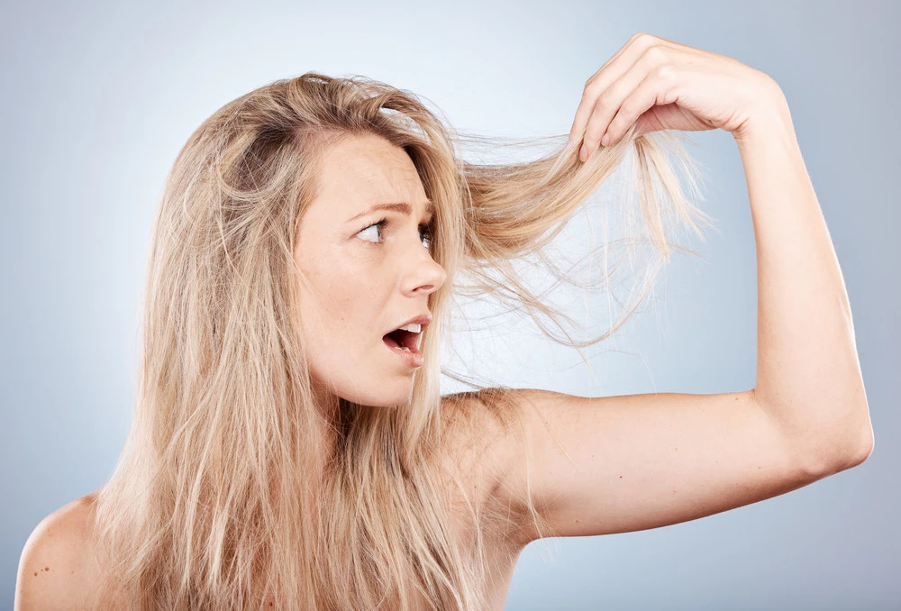 girl surprised by hair loss due to stress