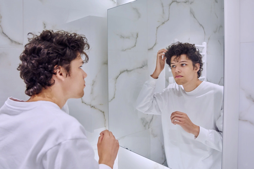 young man doing a hair routine