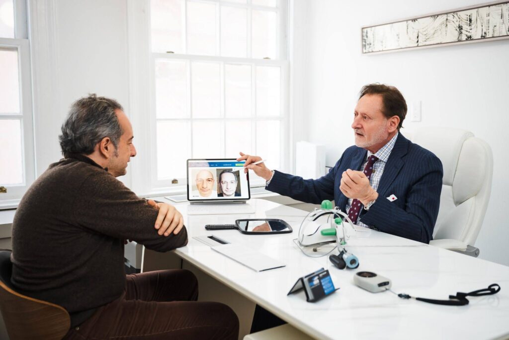 Dr. John P. Cole, during a consultation with a patient in his NYC office.