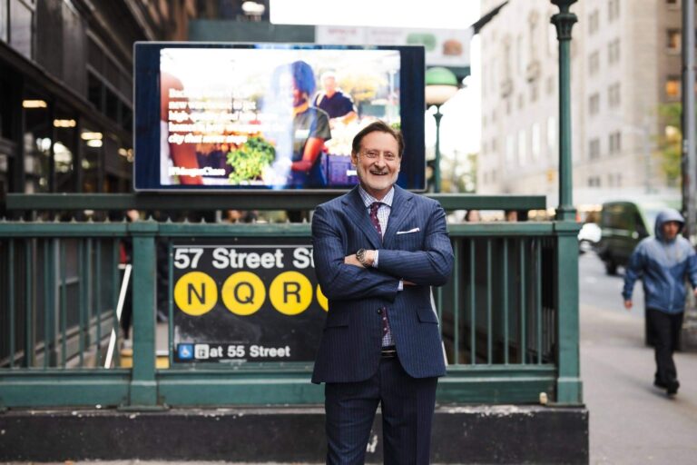 Dr. John P. Cole in front of a subway station.