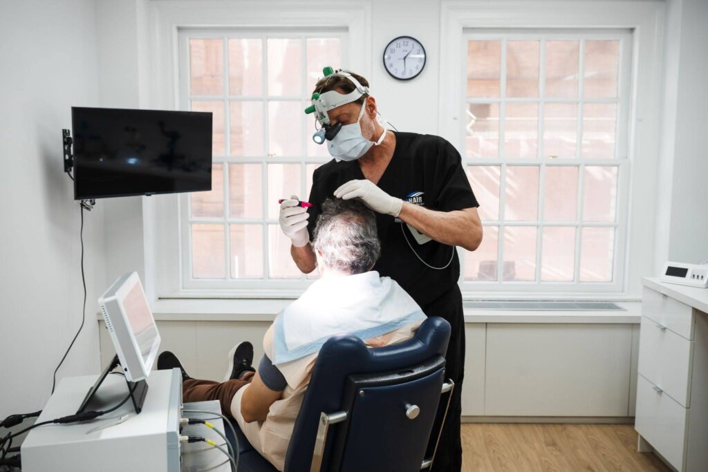 Dr. John P. Cole performing a hair transplant consultation in his NYC office