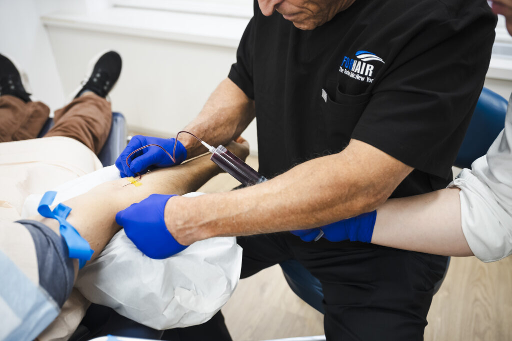 Forhair’s team drawing patient’s blood for CRP (Cytokine Rich Plasma) procedure.